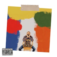 a man sitting on a chair in front of a colorful painting